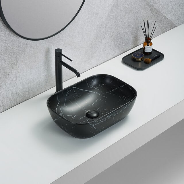 Lukka ELLIPS fine ceramic above counter basin in oval shape, matt marble black finish on the white stone top