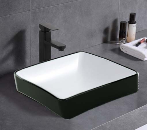 Modern square bathroom vanity basin with black exterior and white interior on grey countertop