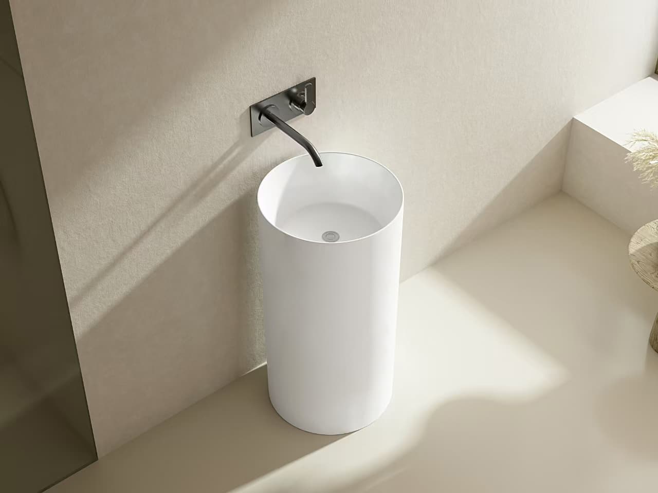 Lukka Carrida Fine Ceramic Free Standing Pedestal Basin, round shape, 445×455×860 mm, Matte White finish with black faucet against a beige wall