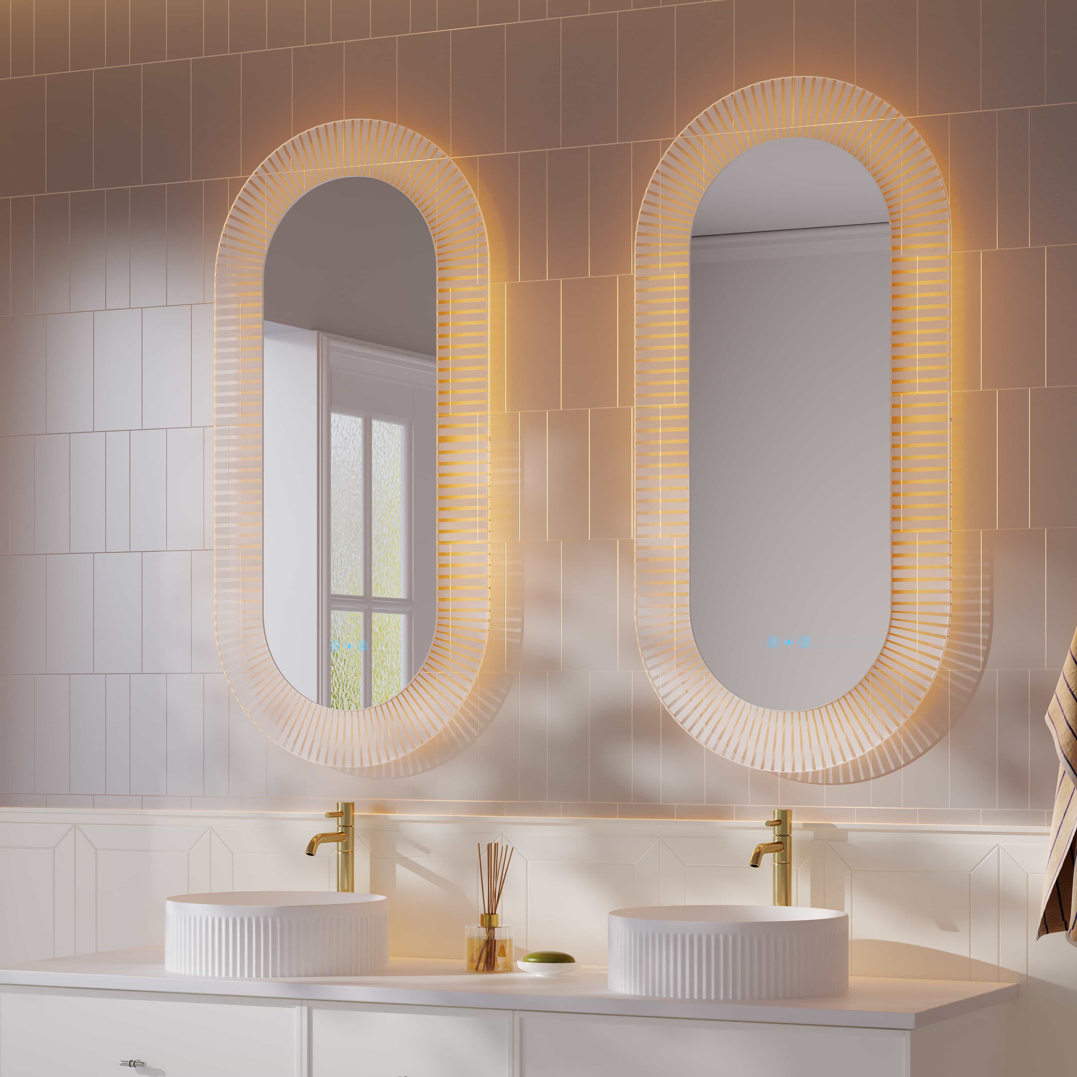 Modern bathroom with LED oval textured mirrors, double vanities, gold taps, and tiled wall