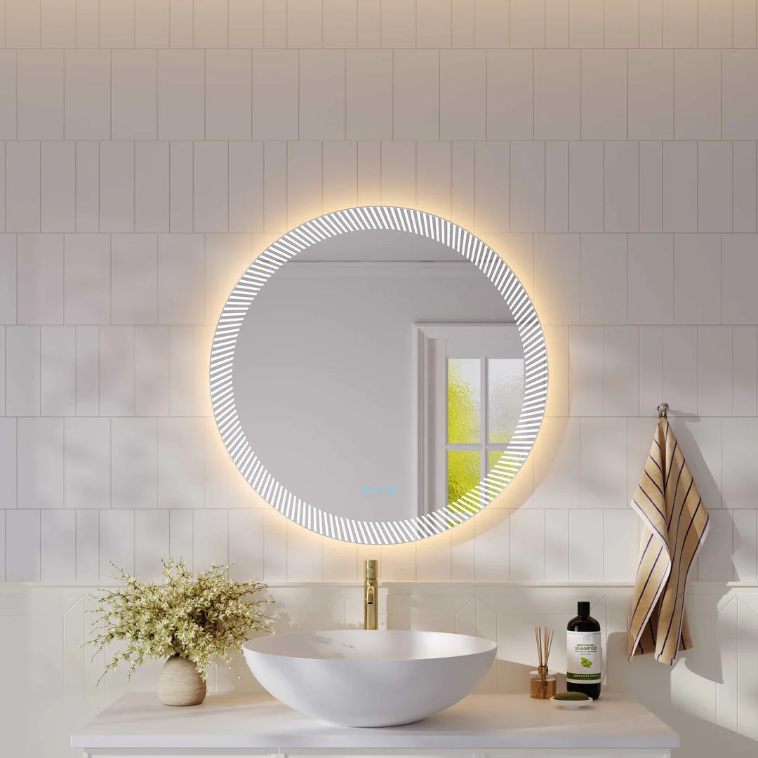 Mercio Freya 800mm LED textured round mirror installed above a vanity in a modern bathroom, showcasing its front and back illumination.