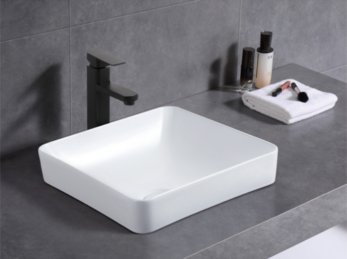 Modern square white bathroom vanity basin with matte black tap on grey countertop