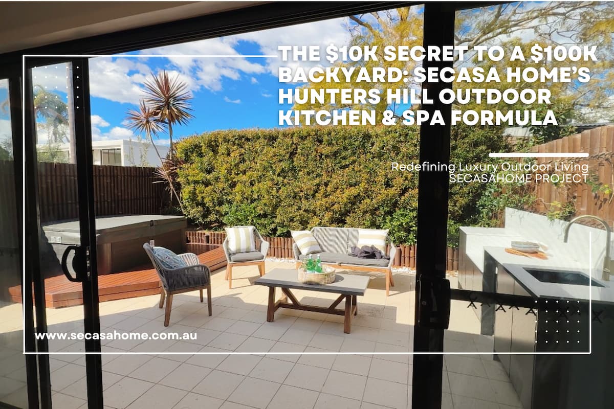 Secasa Home luxury outdoor kitchen and spa area in Hunters Hill, Sydney, viewed through sliding doors. Features a dark grey outdoor kitchen unit, integrated spa, and modern outdoor seating.