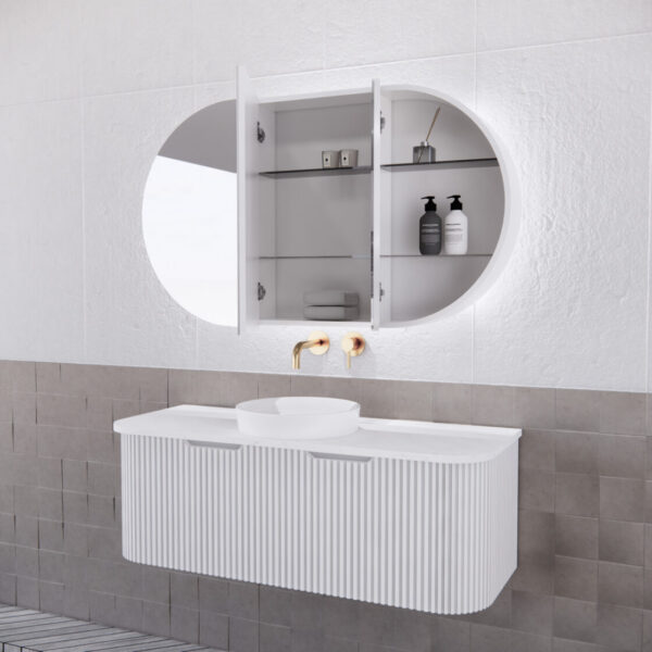 Modern white bathroom vanity with ribbed drawers, round LED mirror cabinet, and gold tapware