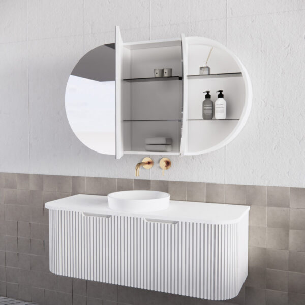 Modern white bathroom vanity with round mirror cabinet, gold tapware, and minimalist design