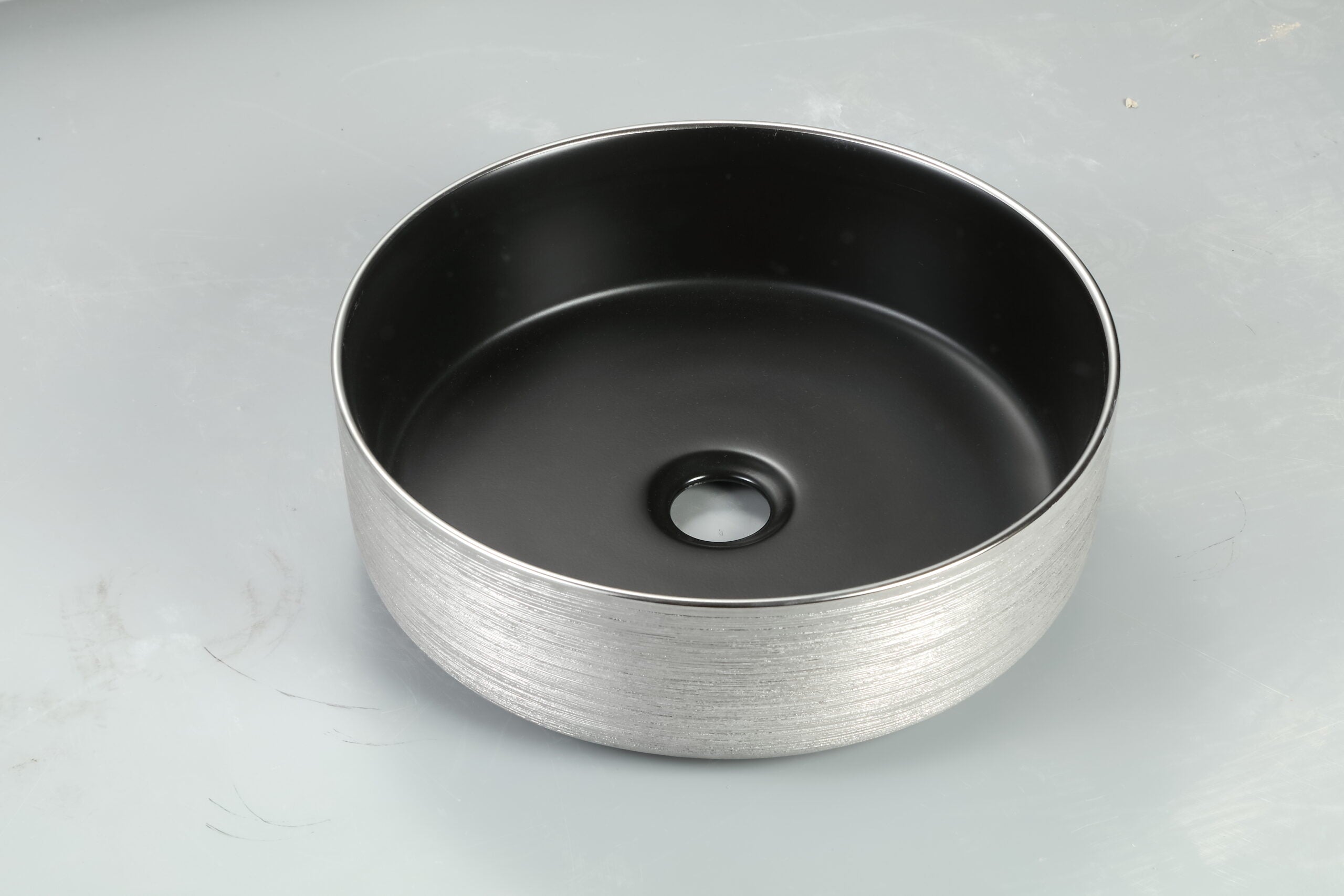 Modern round black bathroom basin with textured silver exterior from Secasa Home