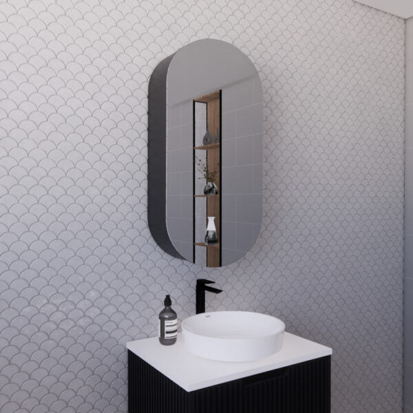Modern bathroom vanity with round basin, black tapware, and oval mirror on patterned wall