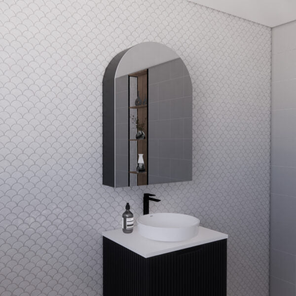 Modern bathroom vanity with black tapware, round mirror cabinet, and scallop tile wall