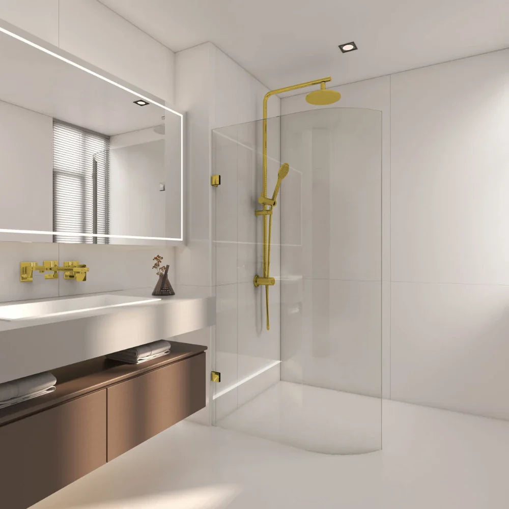 Modern bathroom with gold fixtures, shower enclosure, and mirror.