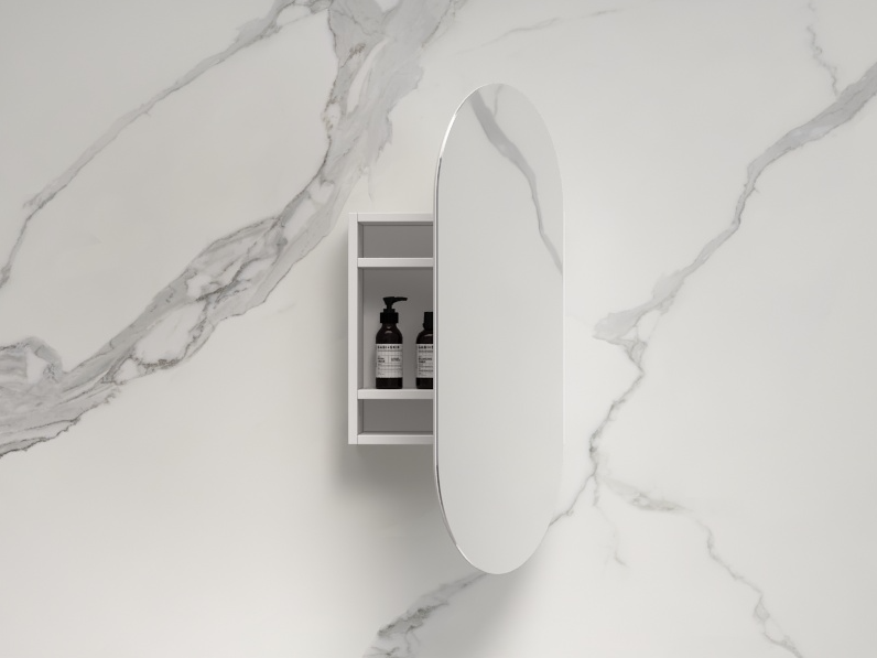 Modern white oval shaving cabinet with mirror door and shelves on marble bathroom wall