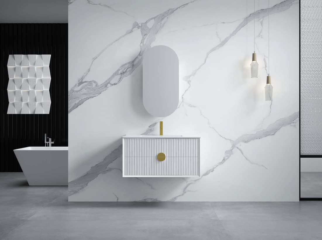 Modern bathroom with white fluted vanity, gold tapware, oval mirror, and marble wall