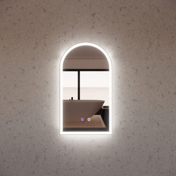 Modern arched LED bathroom mirror on stone wall, reflecting a freestanding bathtub