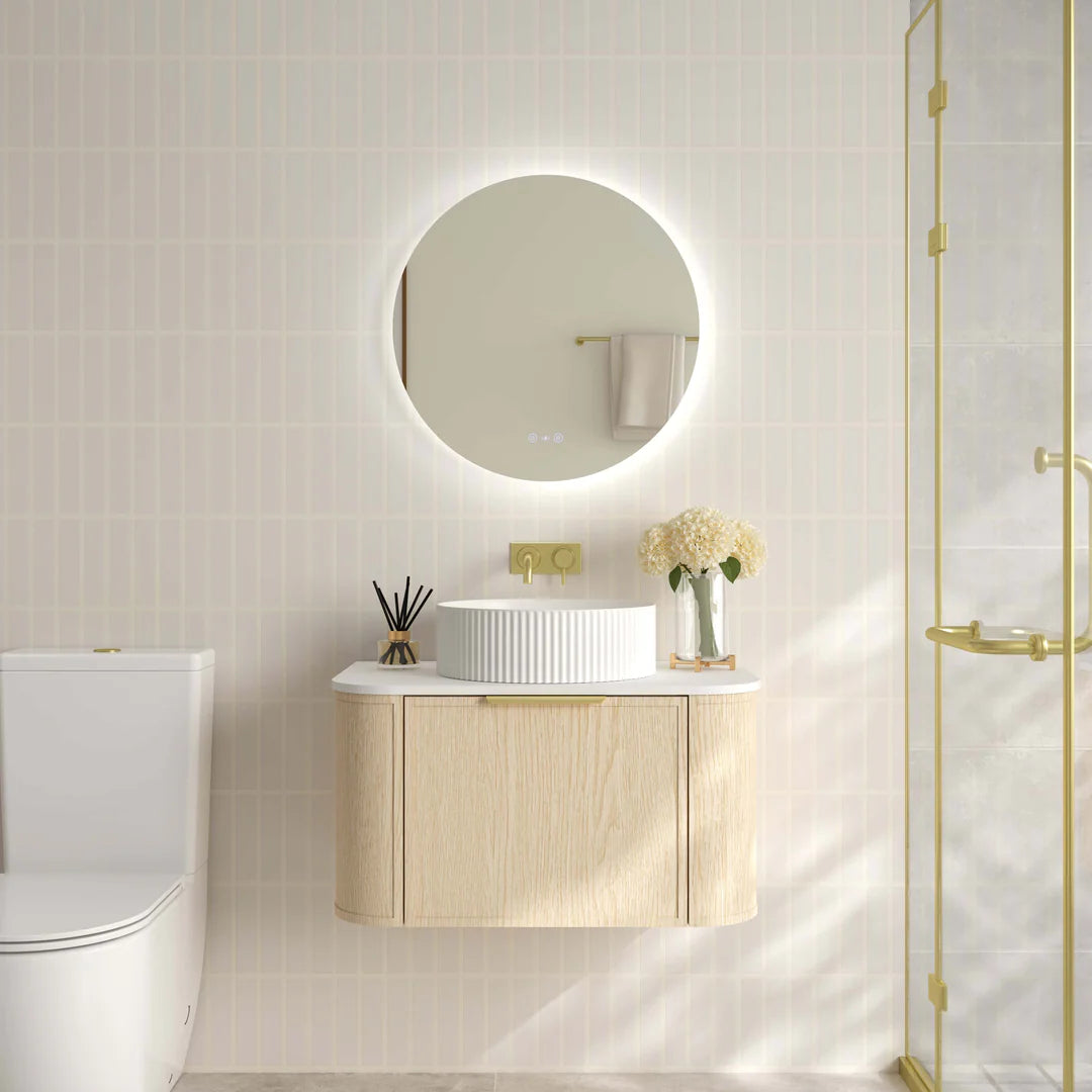 Mercio Elva 740mm Curved Wall-Hung Vanity in Natural Oak, featuring a single soft-close drawer and rounded edges, elegantly styled in a modern bathroom setting with a counter-top basin.