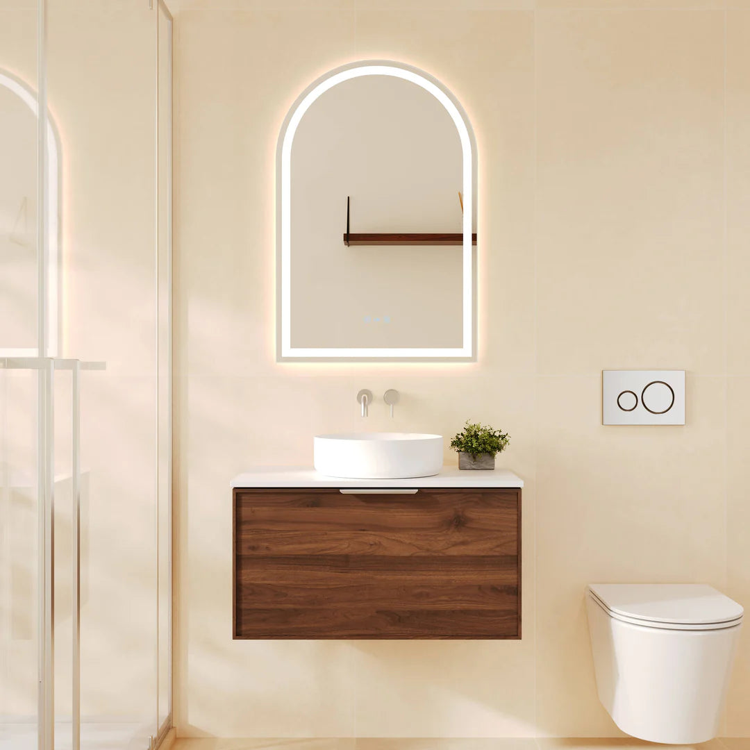 Mercio Paris 740mm Wall-Hung Vanity in Walnut Woodmatt, showcasing a single basin, a curved lip pull handle, and a modern straight-edge design with an arched LED mirror in a minimalist bathroom.