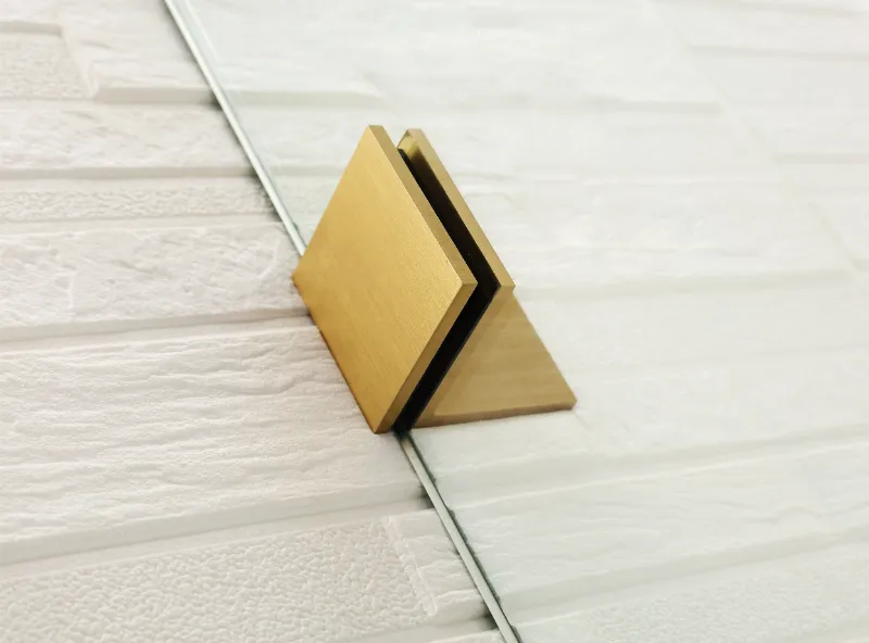 Gold-colored corner protector on a tiled floor of Covey CVP007 shower panel