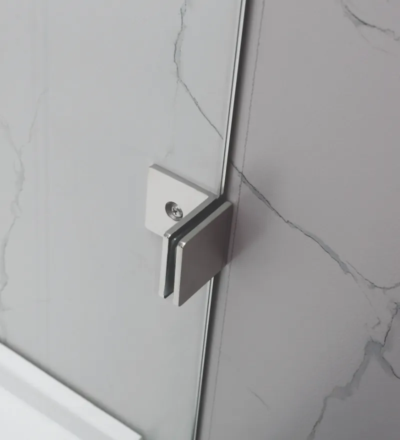 Close-up of a shower door handle on a Covey CVP007 shower panel with marble-patterned wall in the background.