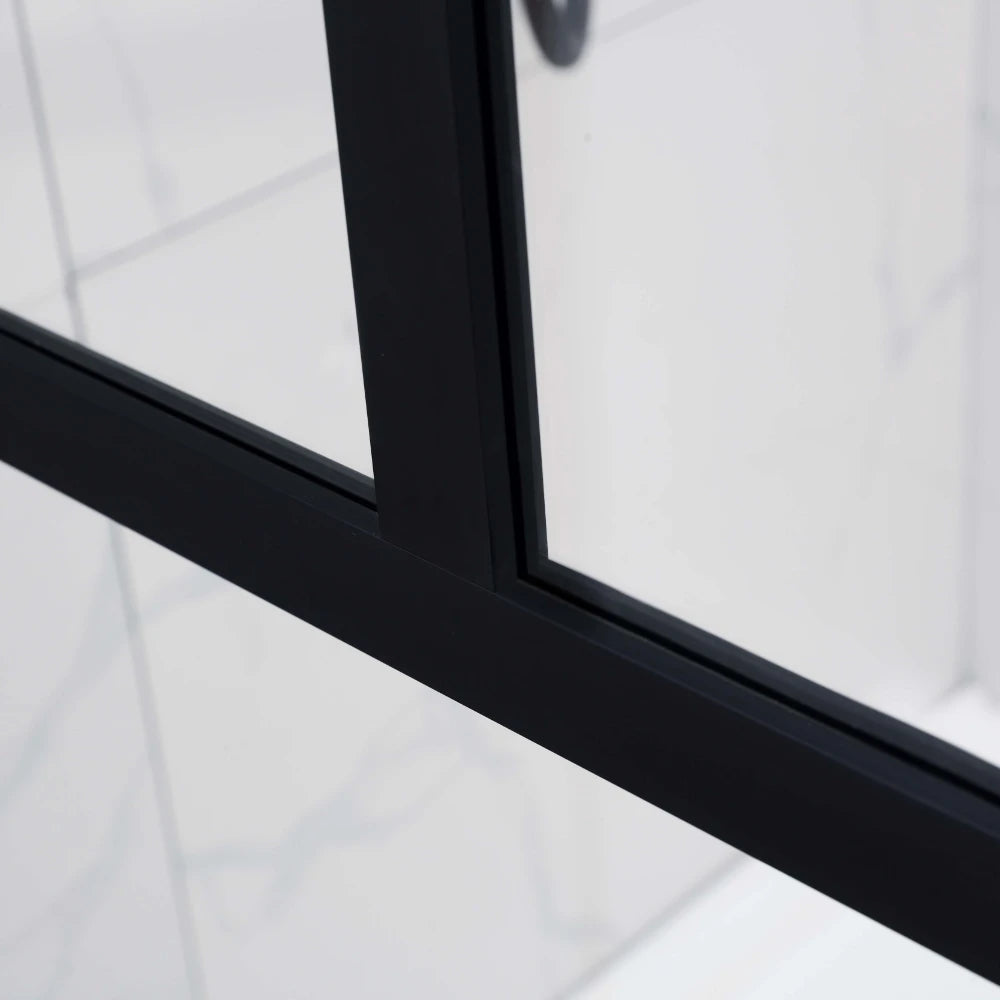 Close-up of a black-framed glass shower enclosure.