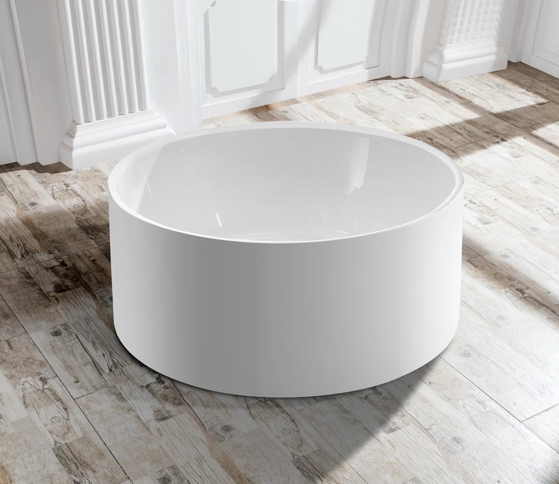 Side profile of the Broadway FS19 round freestanding bath, highlighting its contemporary curved design.