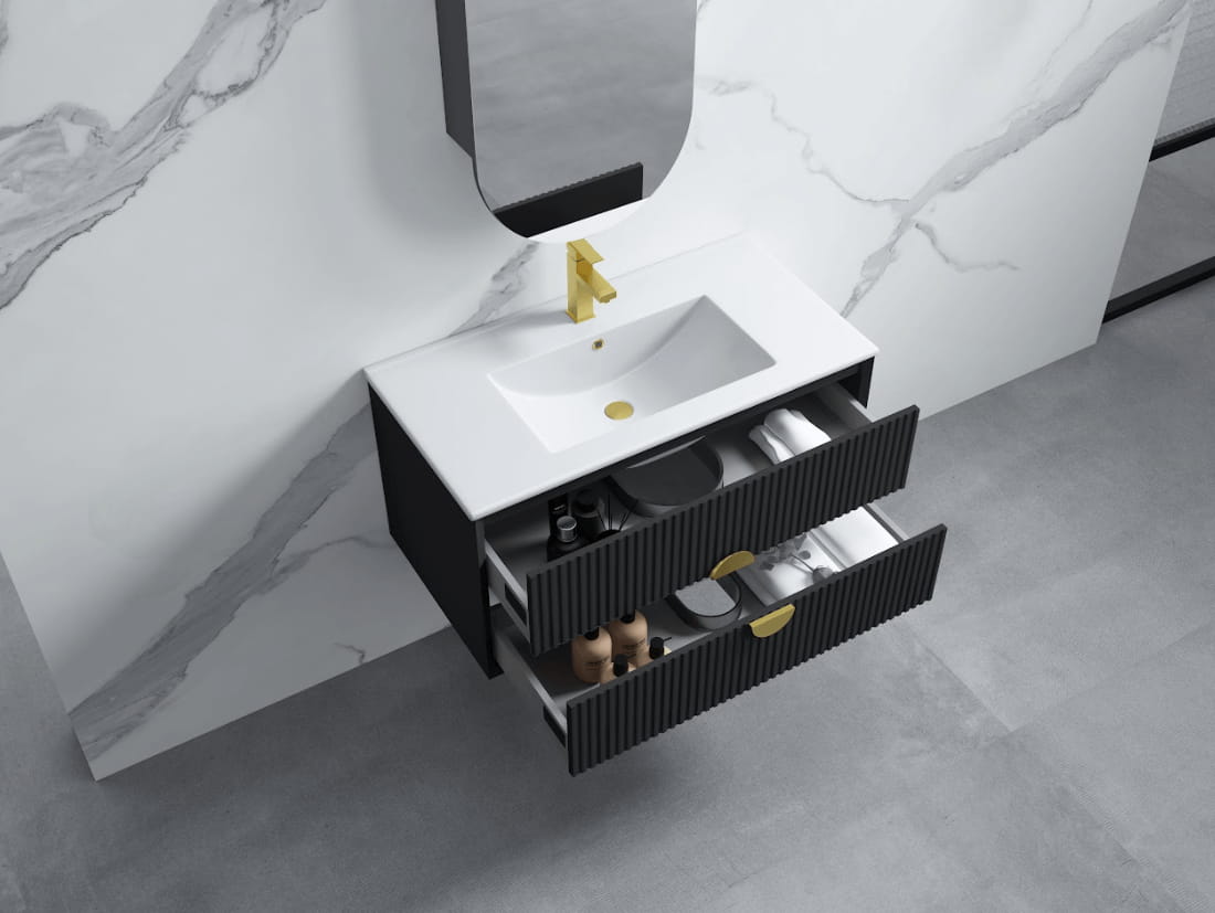 Modern wall-hung black bathroom vanity with soft-close drawers, gold tap, and marble backsplash