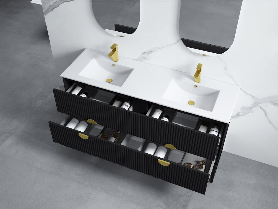 Modern wall-hung black bathroom vanity with double sinks, gold taps, and open drawers.