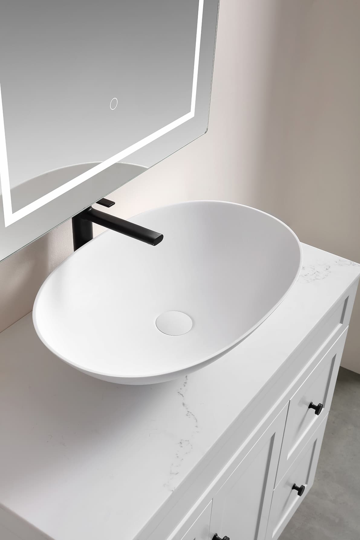 Kirra Solid Surface Art Basin Matt White  on a marble countertop with a black faucet in a modern bathroom.