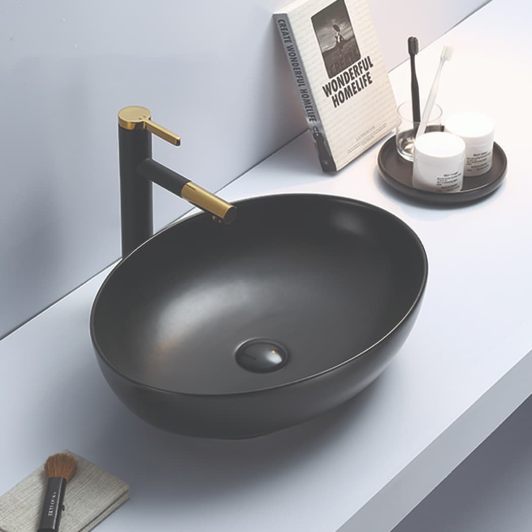 Lukka Carey 520mm oval fine ceramic above counter basin (LK-CRA520-MB) in Matt Black, featuring a seamless, no-overflow design.