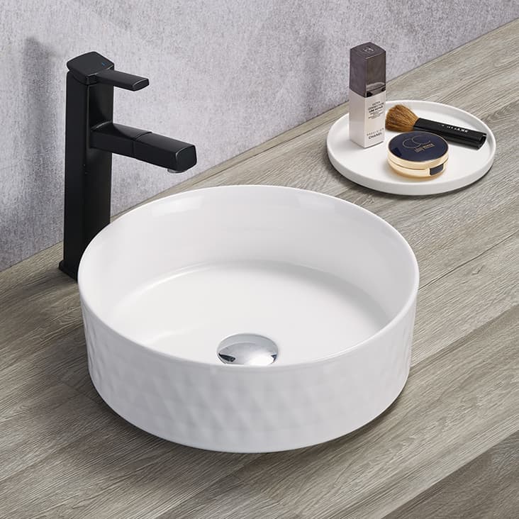 Lukka Ollia Diamond fine ceramic above counter basin in round shape, gloss white finish, 360×360×120 mm, non-overflow, 32 mm waste with black faucet on a wooden countertop