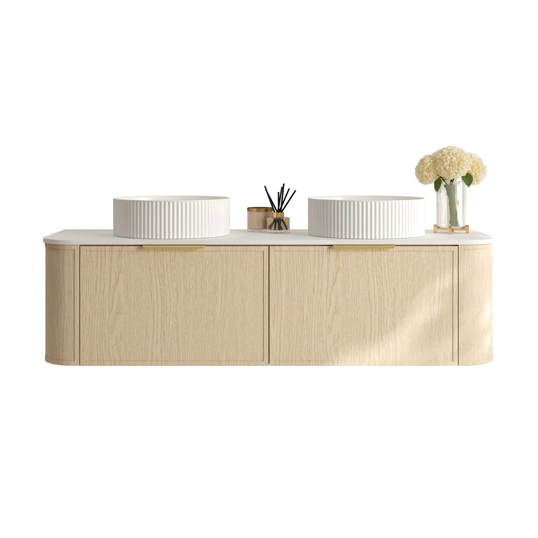 Wide shot of Mercio Elva 1490mm Curved Wall-Hung Vanity in Natural Oak, with two basins, two drawers, and elegant gold accents, defining a luxurious and spacious modern bathroom.