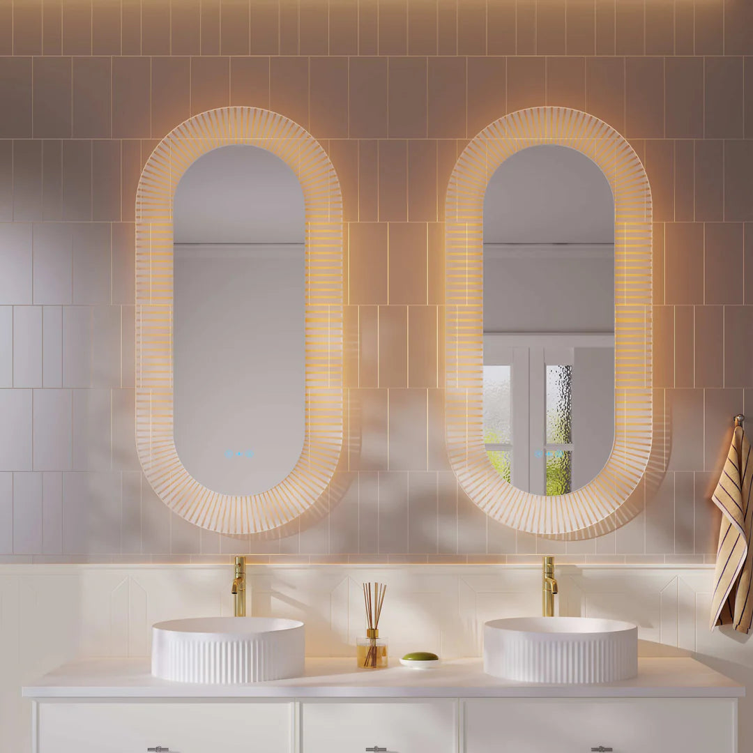 Mercio Freya 600x1200mm LED textured oval mirror installed above a vanity in a modern bathroom, showcasing its front and back illumination.