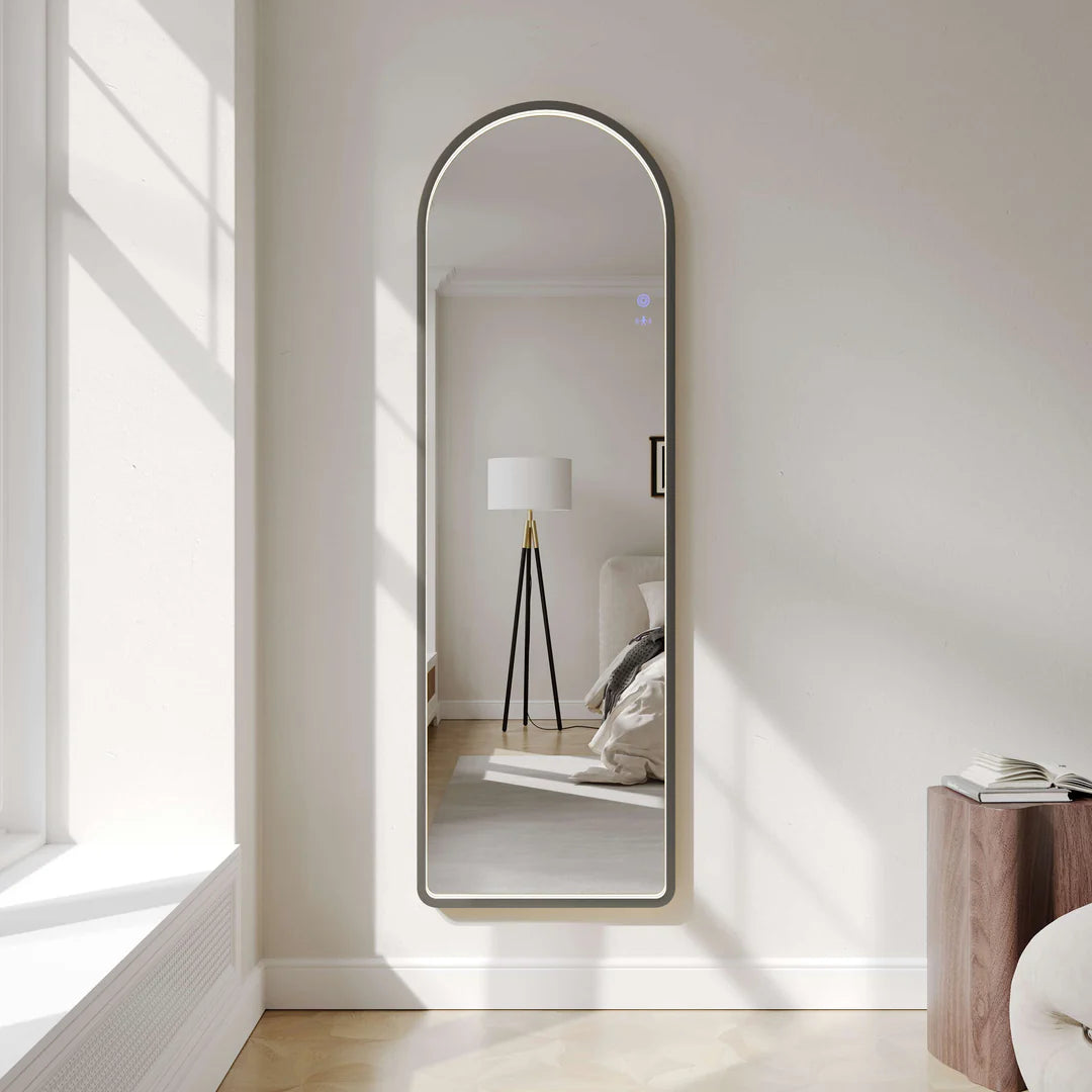 Modern wall-mounted arch LED mirror with gun metal frame in a bright bedroom, Secasa Home