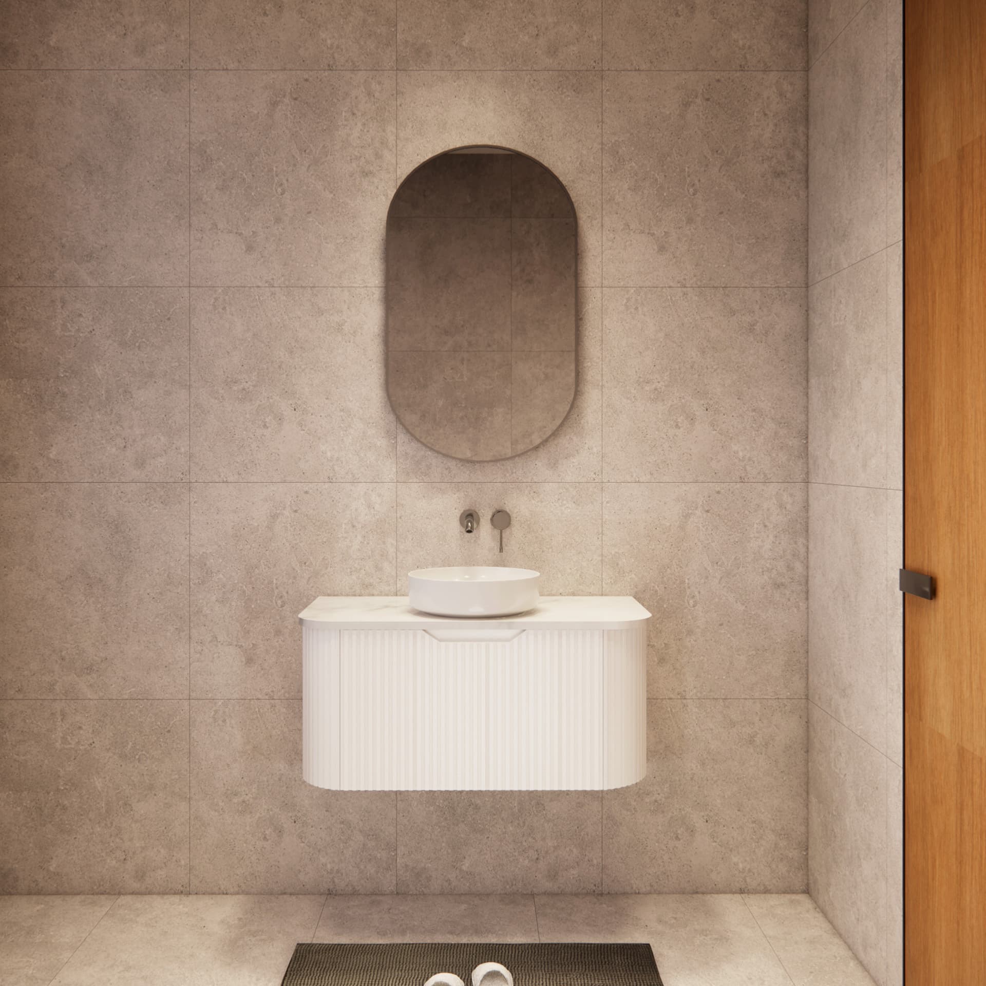 Modern bathroom with matte white curved vanity, round basin, and oval mirror against tiled wall
