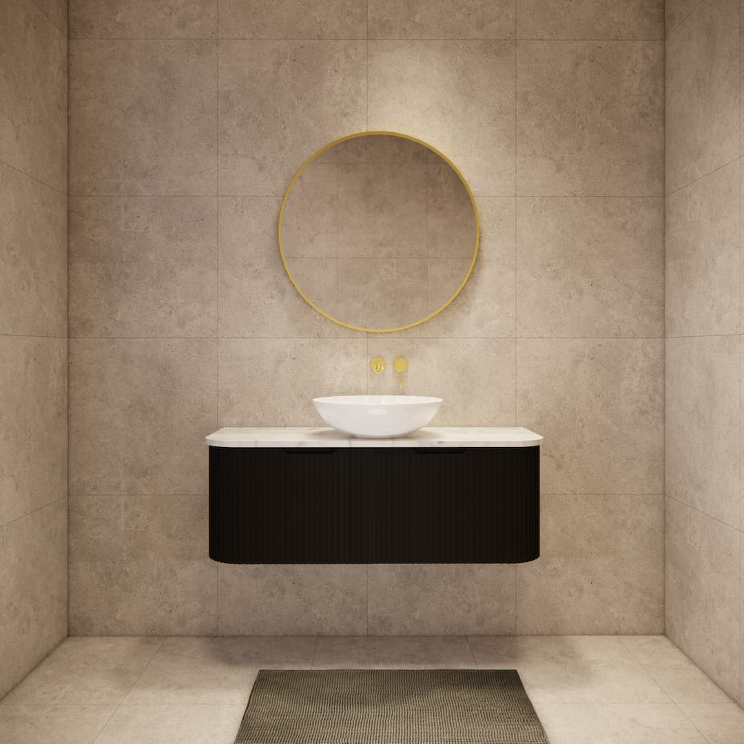 Modern bathroom with matte black fluted floating vanity, round gold mirror, vessel sink.