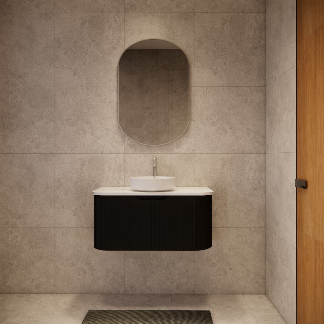 Modern bathroom with matte black fluted vanity, vessel sink, oval mirror, and tiled walls